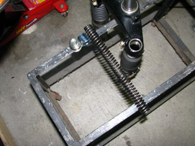 Left to right: fork cap, spacer (not yet shortened), and suspension spring.