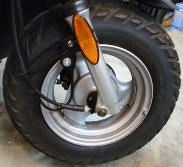 The magnet is epoxied on the rim at the far right.  The smaller cable is for the pickup, and my adapter bracket is black.