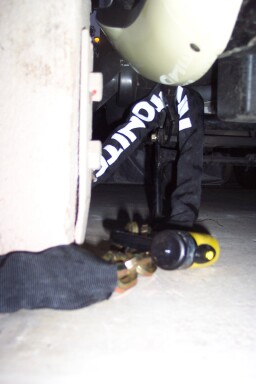 chained through frame bar, in front of exhaust pipe