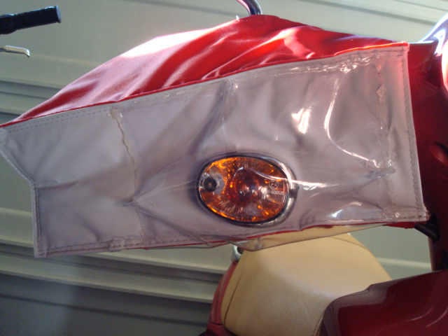 I hot-glued heavy vinyl over the cut-outs for the DOT turn signals to block the wind