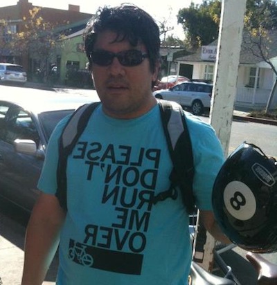 T-shirt has the same message on the back, not reversed. Only works when not wearing a backpack.