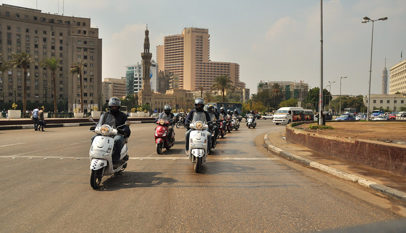 Riding in Tahrir Square, the heart of the Egyptian revolution and you can see our chase cars and traffic polics cars clearing the roads for us at this crowded part of town :)